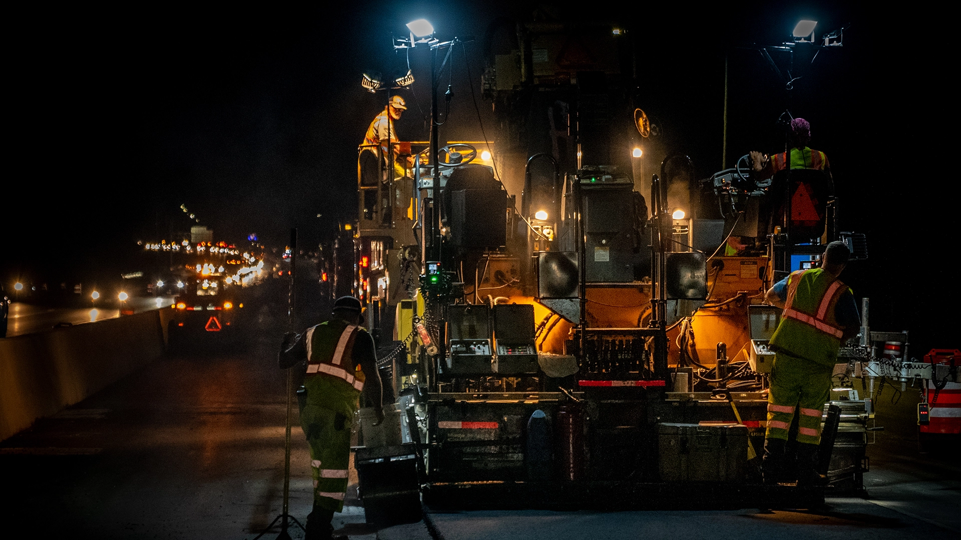 construction workers with equipment at night