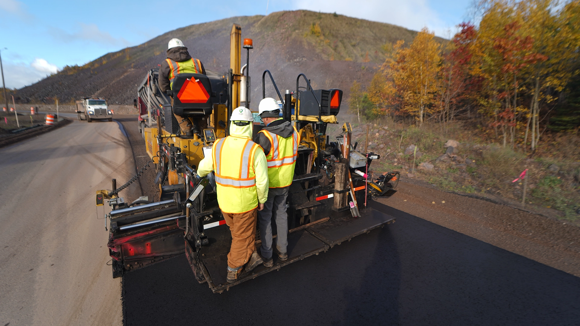 men paving road